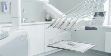A hospital room with a bed and a mirror